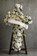 Light of Remembrance funeral flower cross of white chrysanthemums, cream roses, lilies and eucalyptus on a stand with a white sash — funeral flowers IFIORA Warsaw