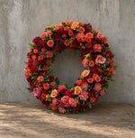 Orange and red wreath of roses, carnations and solidago, XL arrangement shown as a reference